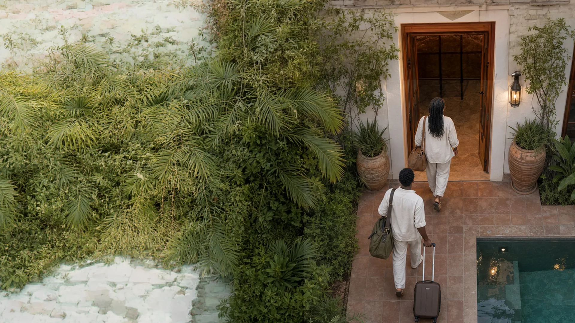 Guests arriving at a courtyard entrance of a South African guesthouse